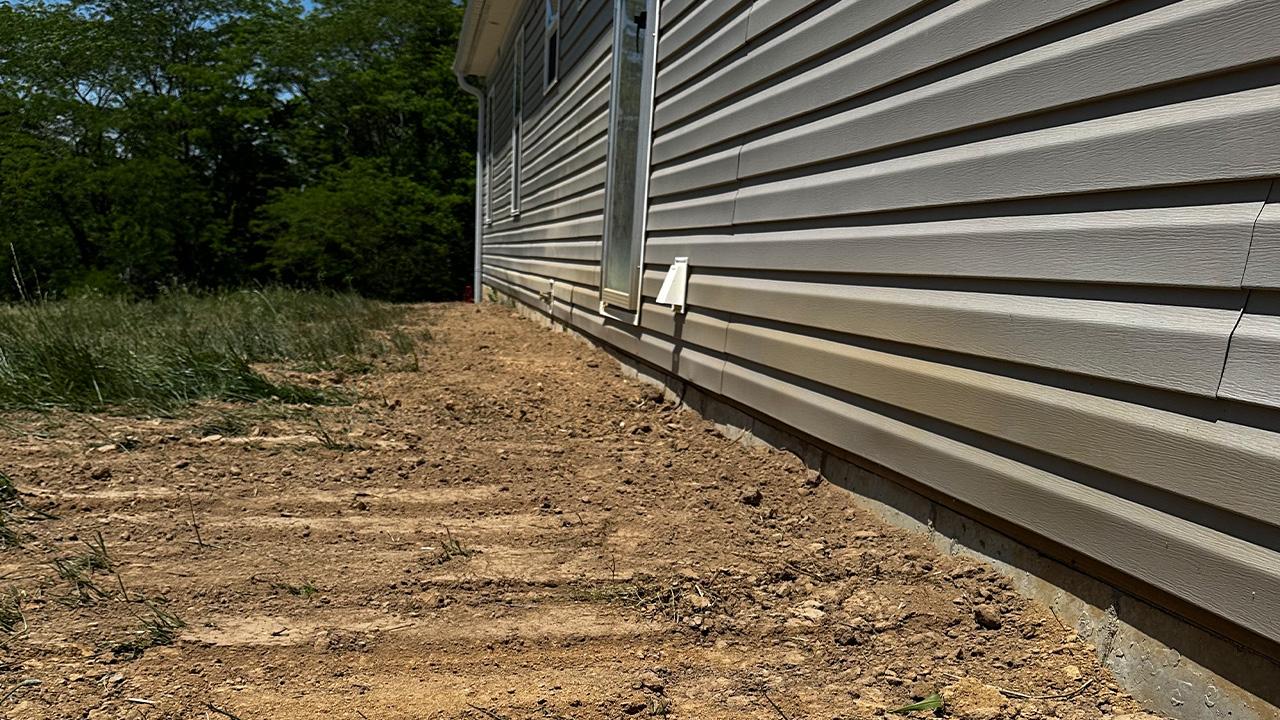 Regraded Memphis lawn sloping water away from the house
